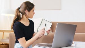 focused-woman-using-laptop-while-attending-online-webinar-4492189